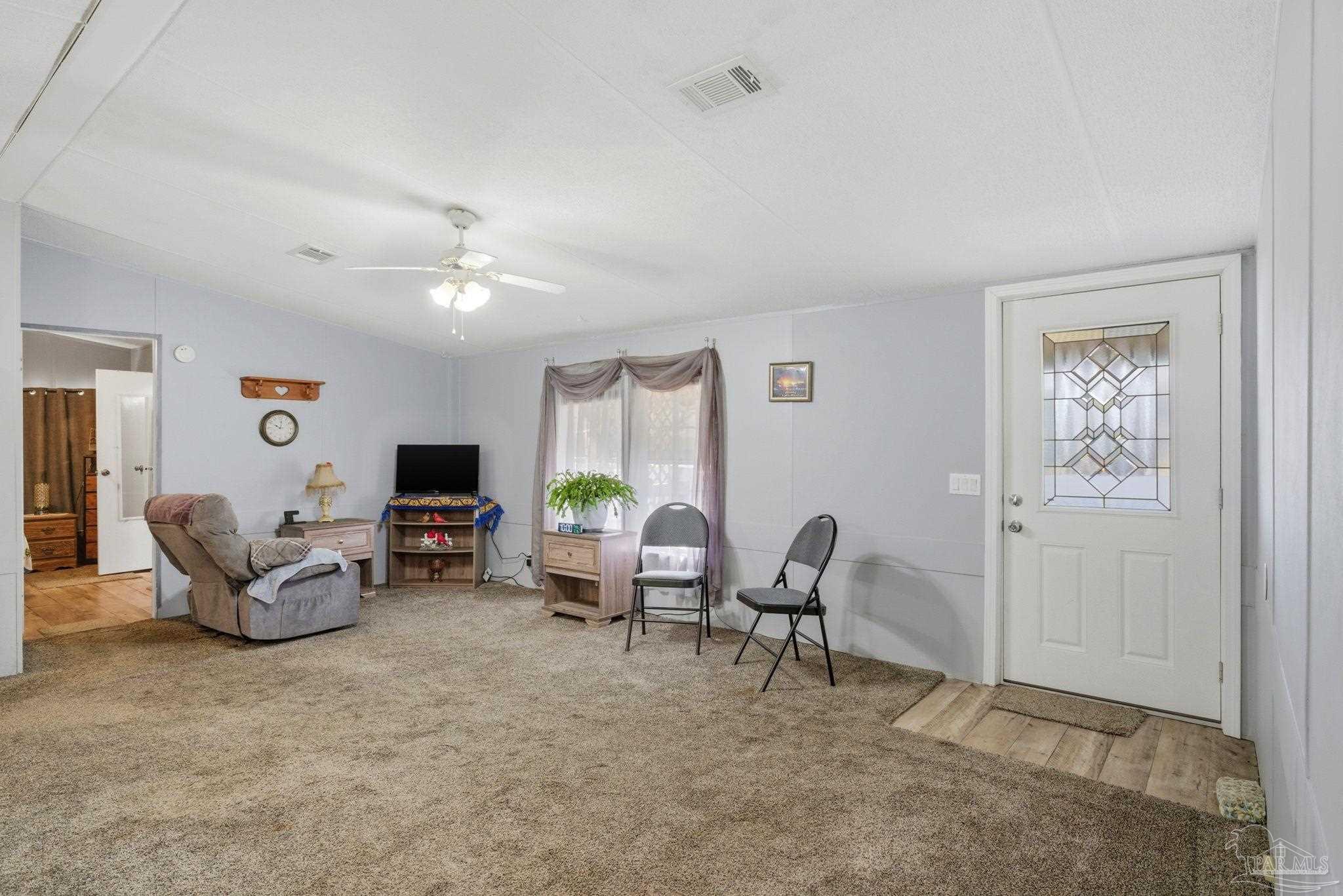 8962 Bluebell Street Milton, FL 32583 - Photo 8 of 35 a living room with furniture and a flat screen tv