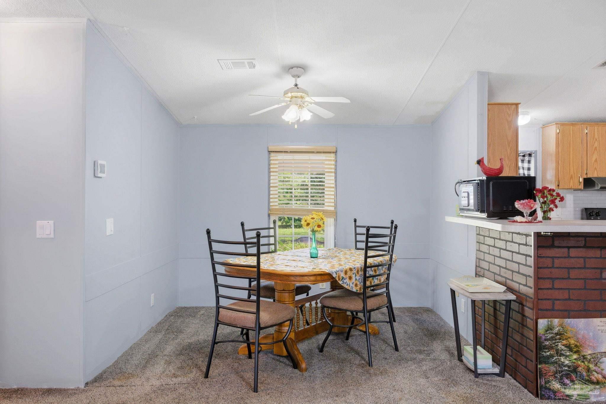 8962 Bluebell Street Milton, FL 32583 - Photo 10 of 35 a dining room with furniture and window