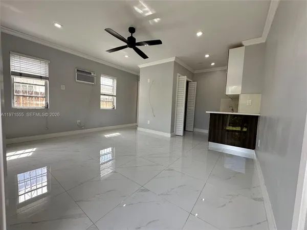 a kitchen with cabinets and wooden floor