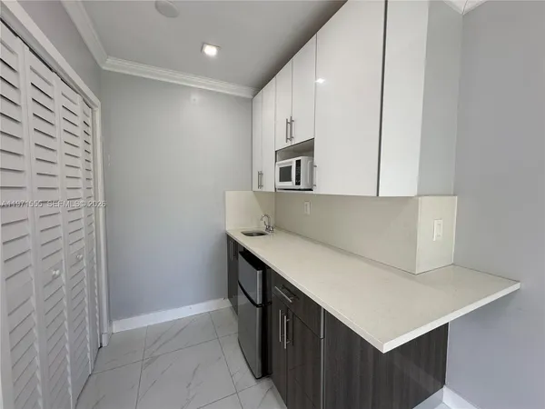 a view of a hallway with washer and dryer