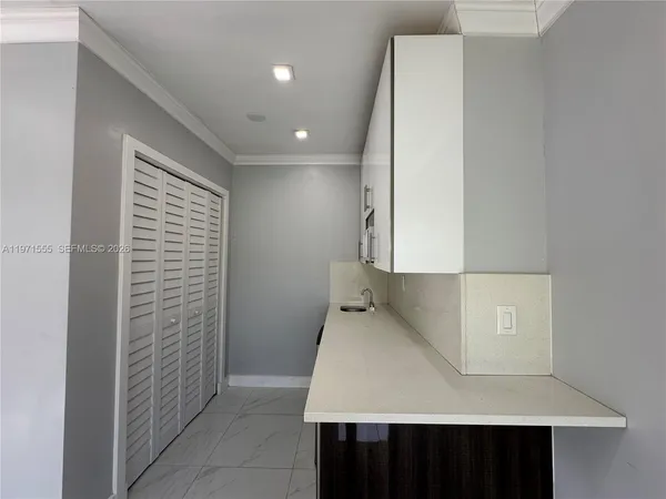 a kitchen with a sink and cabinets