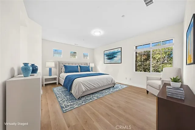 a bedroom with a large bed and a window