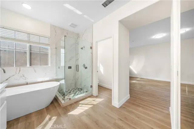 a spacious bathroom with a bathtub and a shower