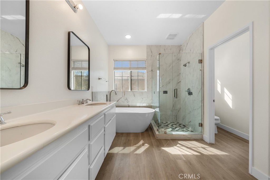 4539 Rivergate Court Riverside, CA 92505 - Photo 16 of 29 a bathroom with a double vanity sink toilet mirror and bathtub