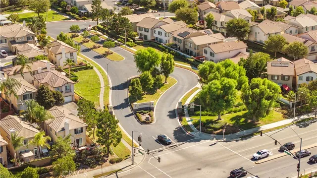 an aerial view of residential houses with outdoor space and swimming pool