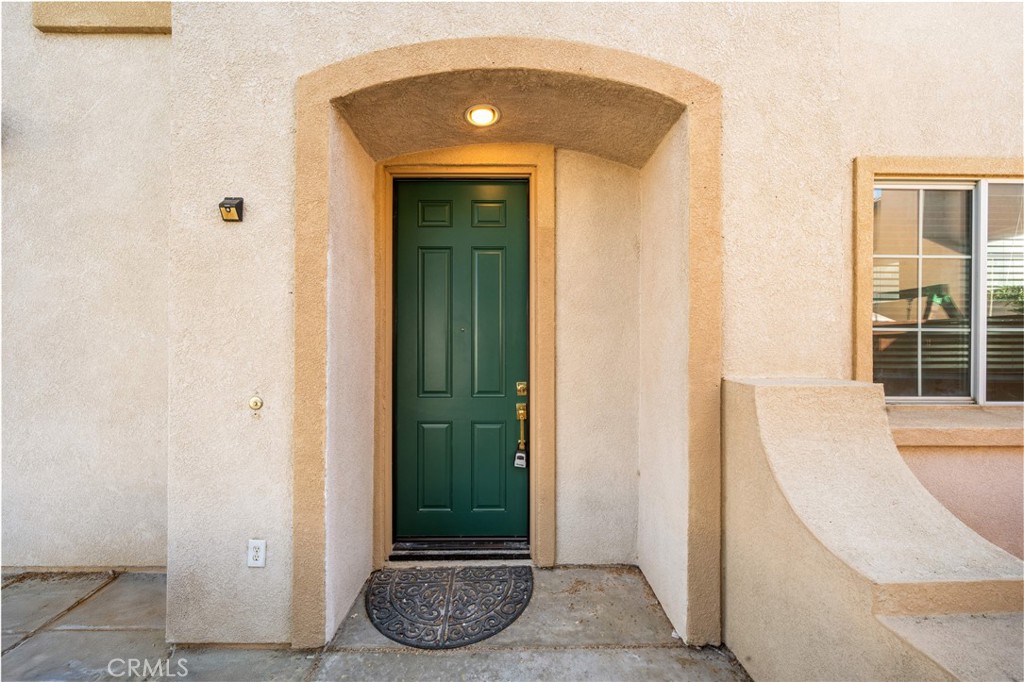 4539 Rivergate Court Riverside, CA 92505 - Photo 3 of 29 a view of a hallway with wooden floor and a potted plant