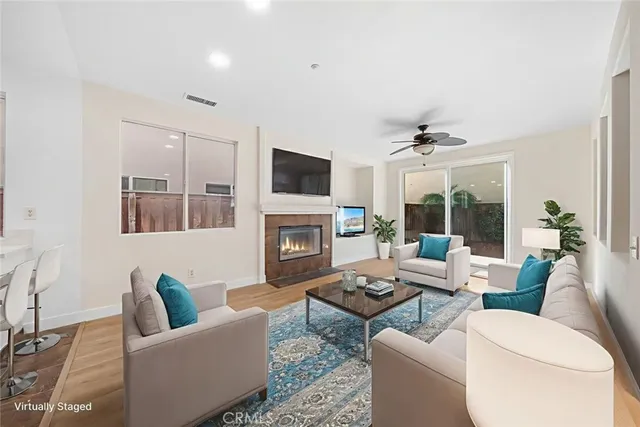 a living room with furniture a fireplace and a flat screen tv