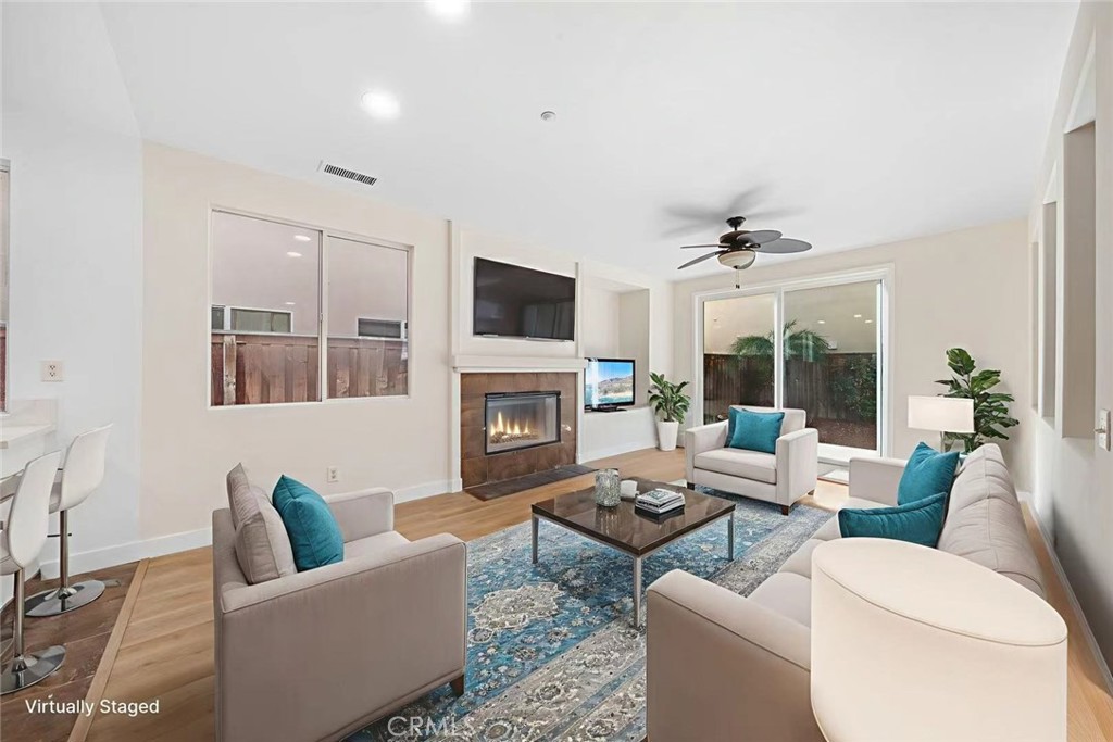 4539 Rivergate Court Riverside, CA 92505 - Photo 5 of 29 a living room with furniture a fireplace and a flat screen tv