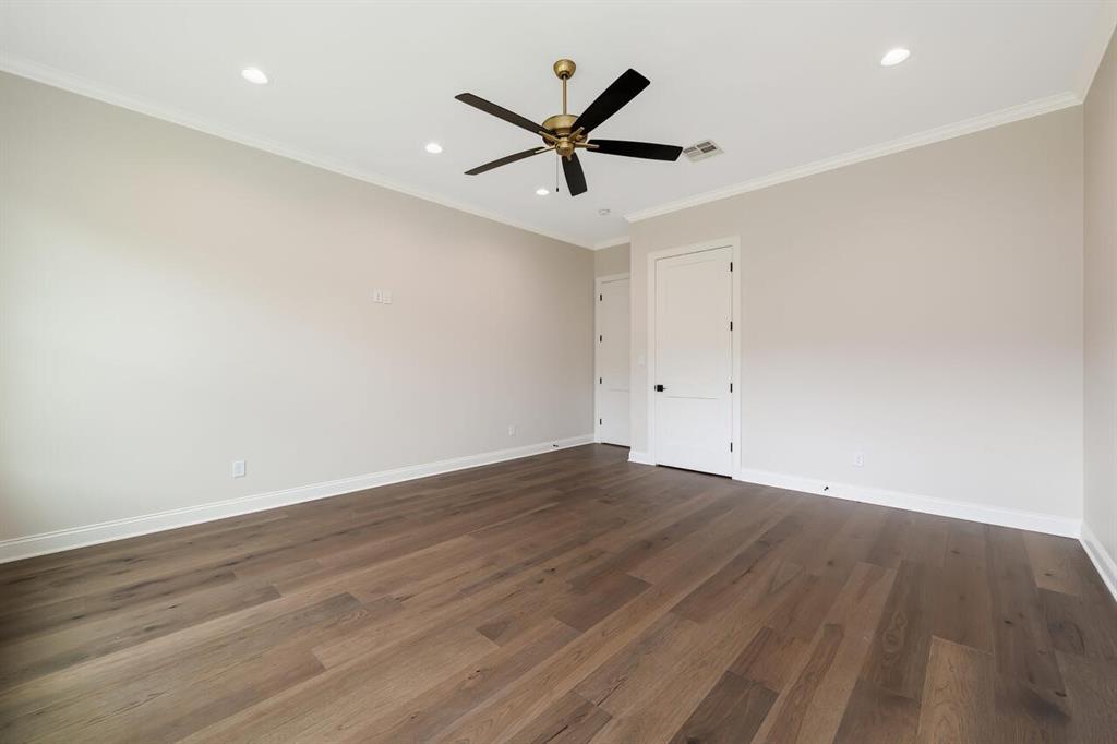 8005 Bee Cave Road China Spring, TX 76633 - Photo 38 of 40 an empty room with wooden floor and a ceiling fan