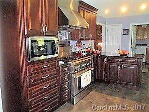 1610 Center Road Chester, SC 29706 - Photo 2 of 24 a kitchen with stainless steel appliances granite countertop a stove and a microwave