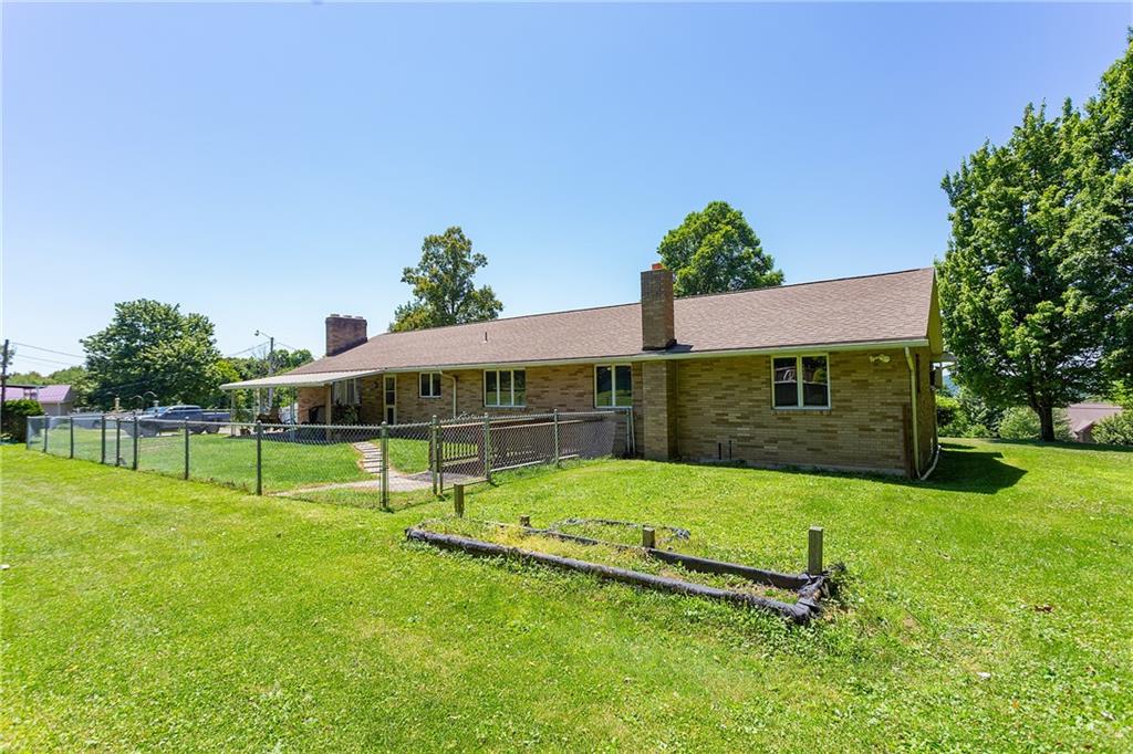 330 Cemetery Road Perryopolis, PA 15473 - Photo 6 of 16 a view of a backyard with a garden and fire pit