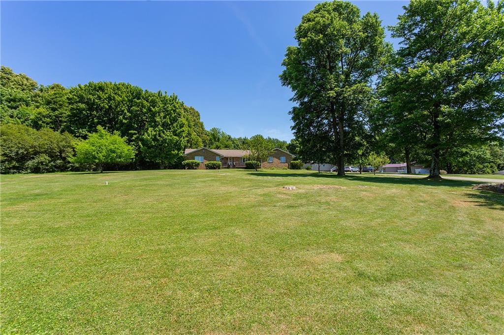 330 Cemetery Road Perryopolis, PA 15473 - Photo 8 of 16 a view of a green field with trees in the background
