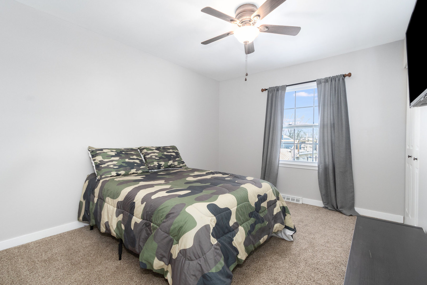 25 North Bereman Road Montgomery, IL 60538 - Photo 12 of 28 a bedroom with a bed and a chandelier
