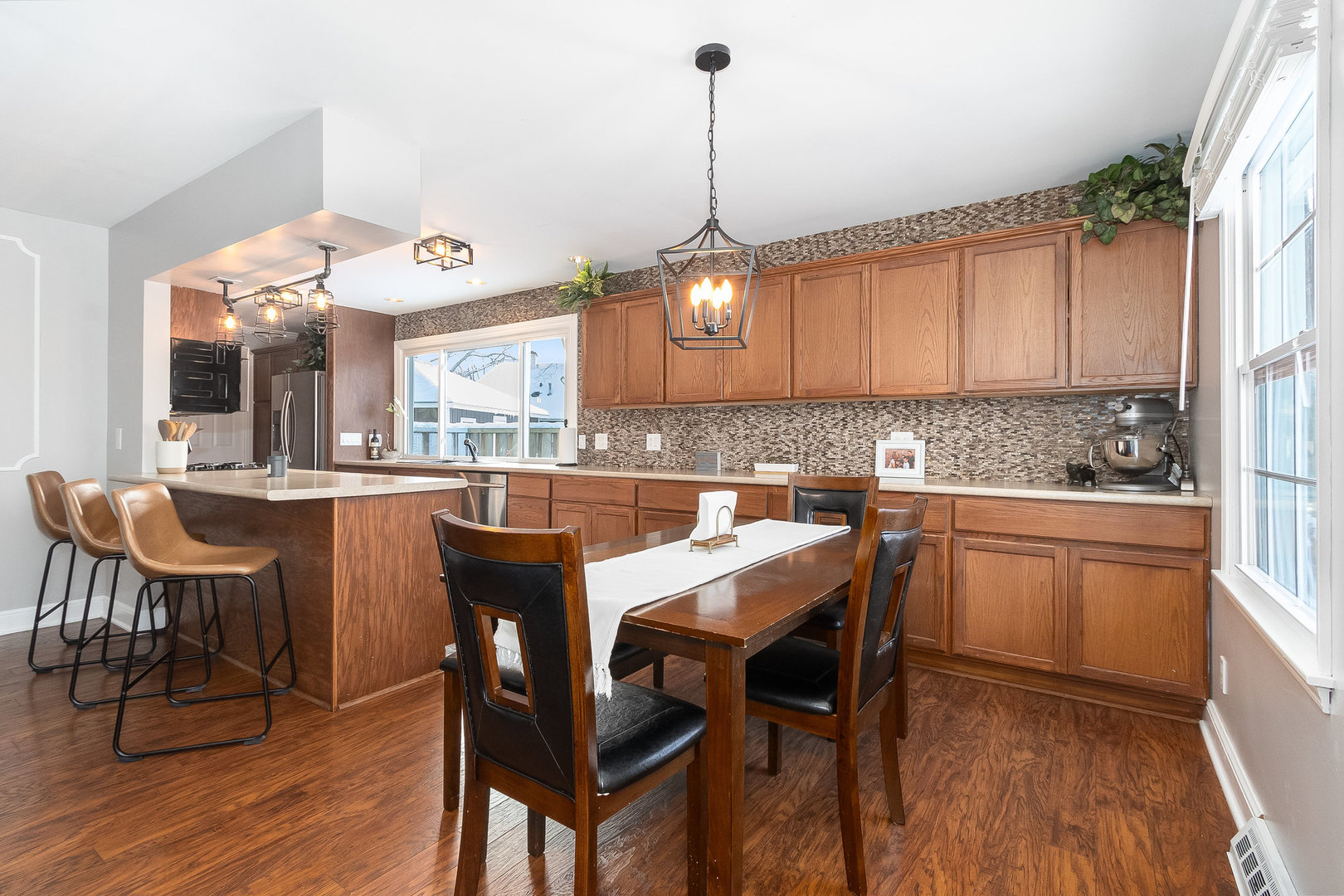 25 North Bereman Road Montgomery, IL 60538 - Photo 5 of 28 a kitchen with a dining table chairs and white cabinets