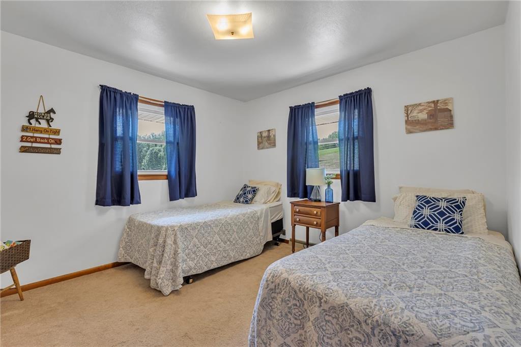 383 Ridgemont Drive Midland, PA 15059 - Photo 37 of 44 a bedroom with two beds and a window