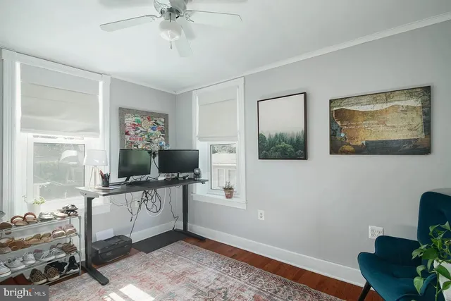 a workspace with wooden floor and a window
