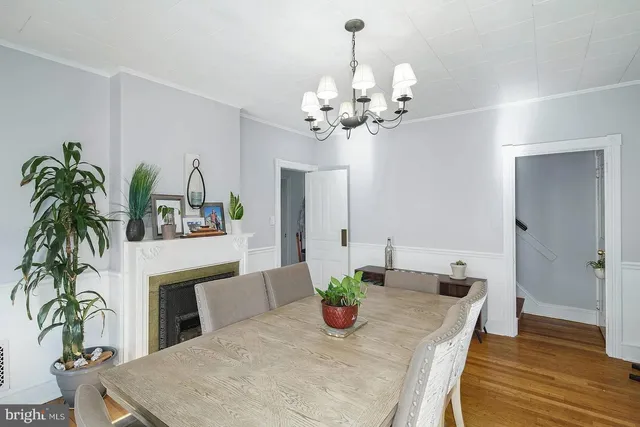 a view of a dining room with furniture wooden floor and a chandelier
