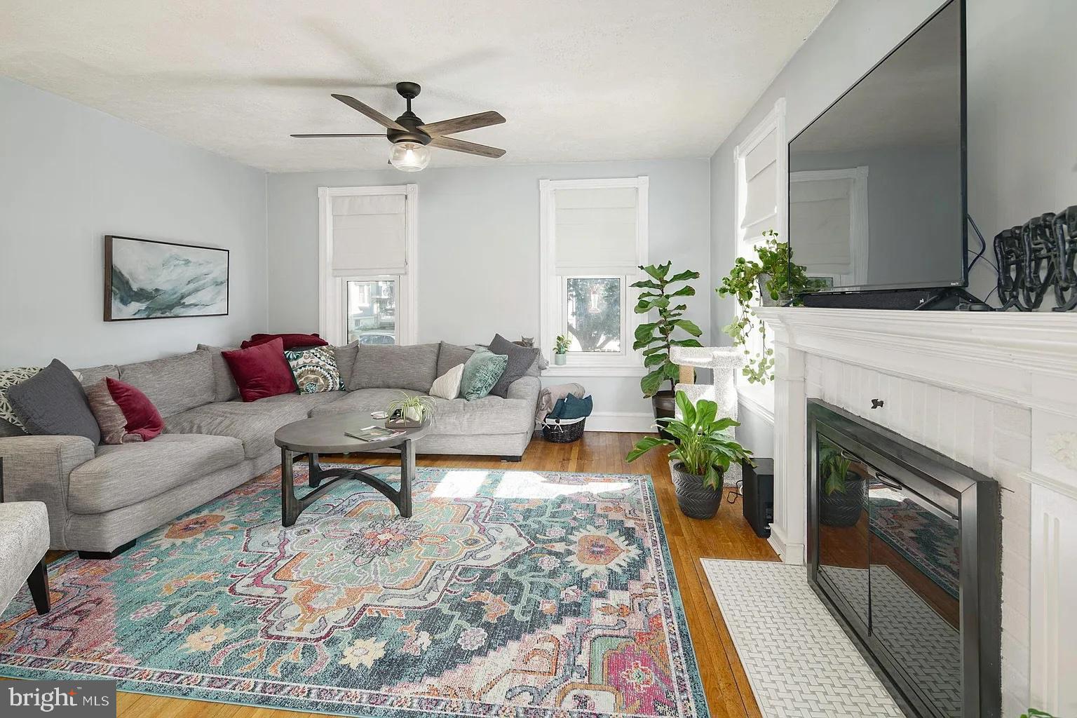 19 West Summit Avenue Haddonfield, NJ 08033 - Photo 7 of 12 a living room with furniture a fireplace and a ceiling fan