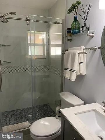 a bathroom with a sink toilet and shower