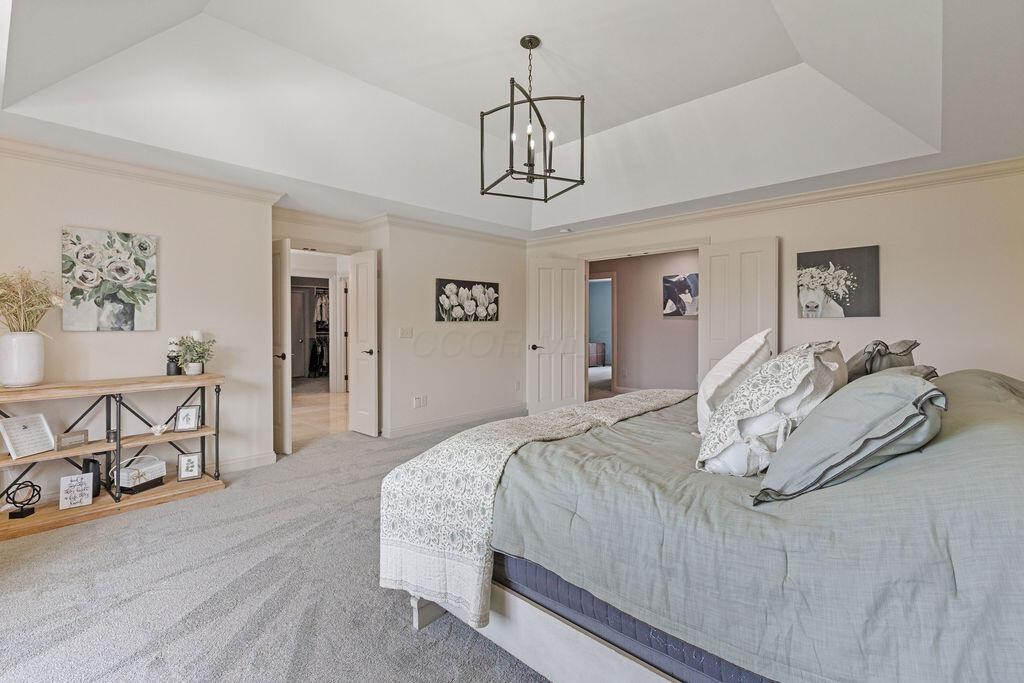 2570 Jewett Road Powell, OH 43065 - Photo 49 of 104 • New grey carpet ~ 2025 • Ivory painted walls • Crown molding • Tray ceiling • Chandelier • French doors • (2) wall sconces • Drapes remain