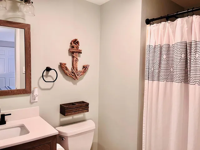 a bathroom with a toilet a sink and shower