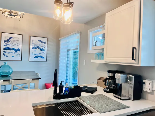 a living room with dining table and paintings