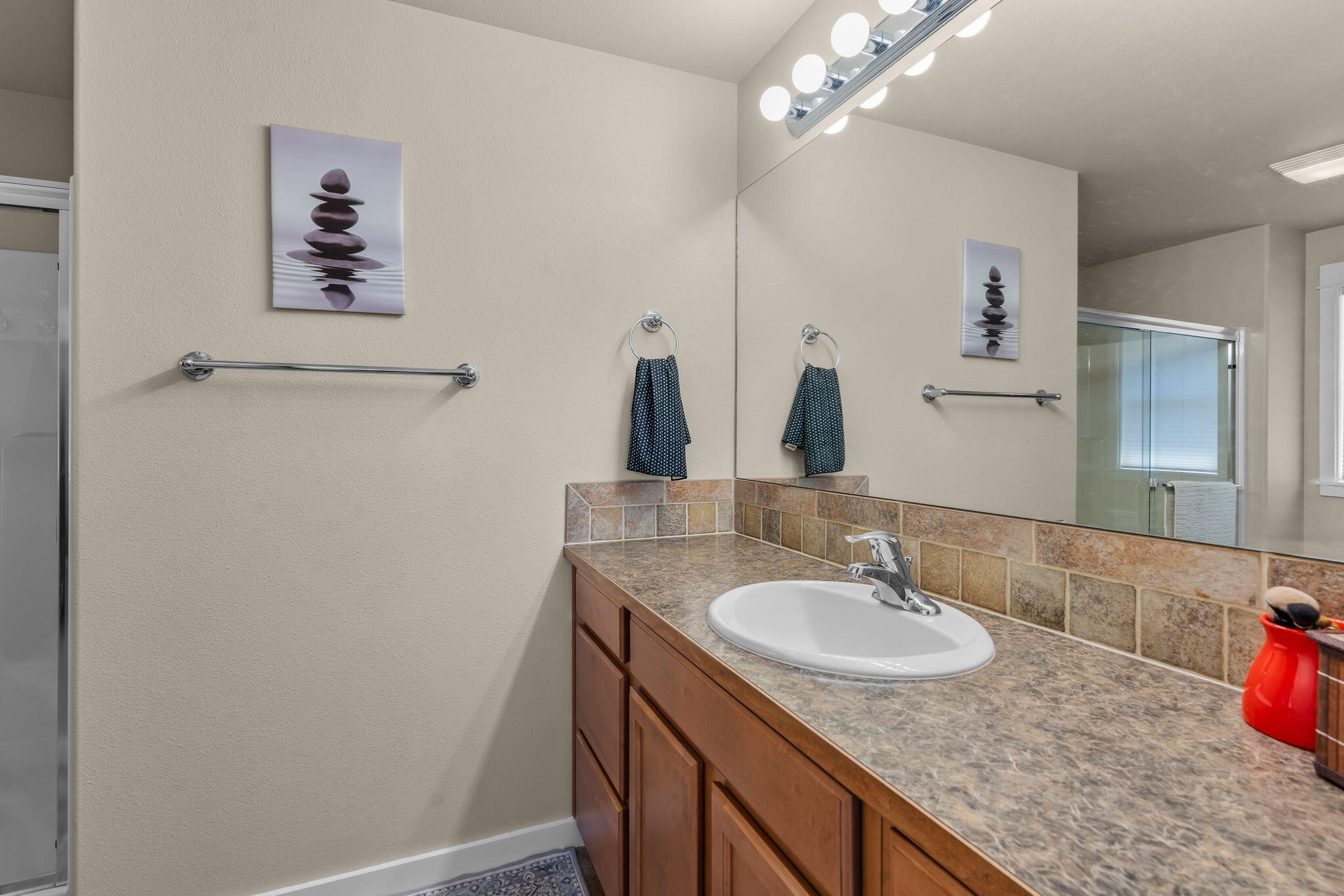 3714 Southwest 29th Street Redmond, OR 97756 - Photo 13 of 21 a bathroom with a granite countertop sink a large mirror and vanity