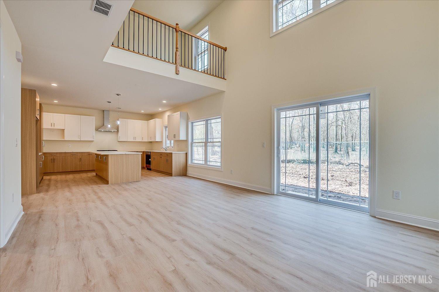 90 Hancock Road Piscataway, NJ 08854 - Photo 14 of 50 a large white kitchen with wooden floors and kitchen view