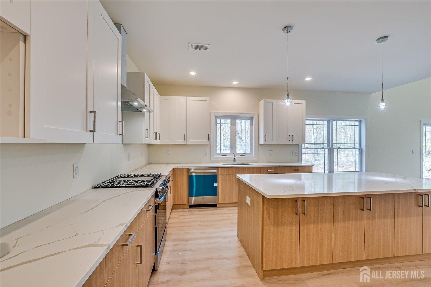 90 Hancock Road Piscataway, NJ 08854 - Photo 18 of 50 a kitchen with kitchen island granite countertop a sink a counter space and stainless steel appliances