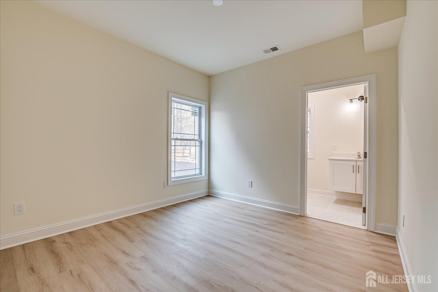 90 Hancock Road Piscataway, NJ 08854 - Photo 20 of 50 a view of an empty room with wooden floor and a window