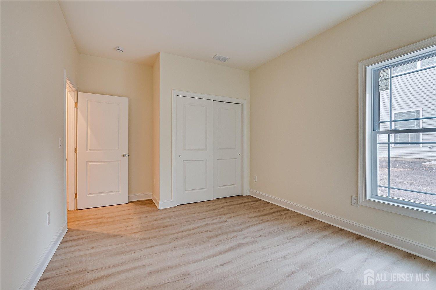 90 Hancock Road Piscataway, NJ 08854 - Photo 21 of 50 an empty room with wooden floor and windows