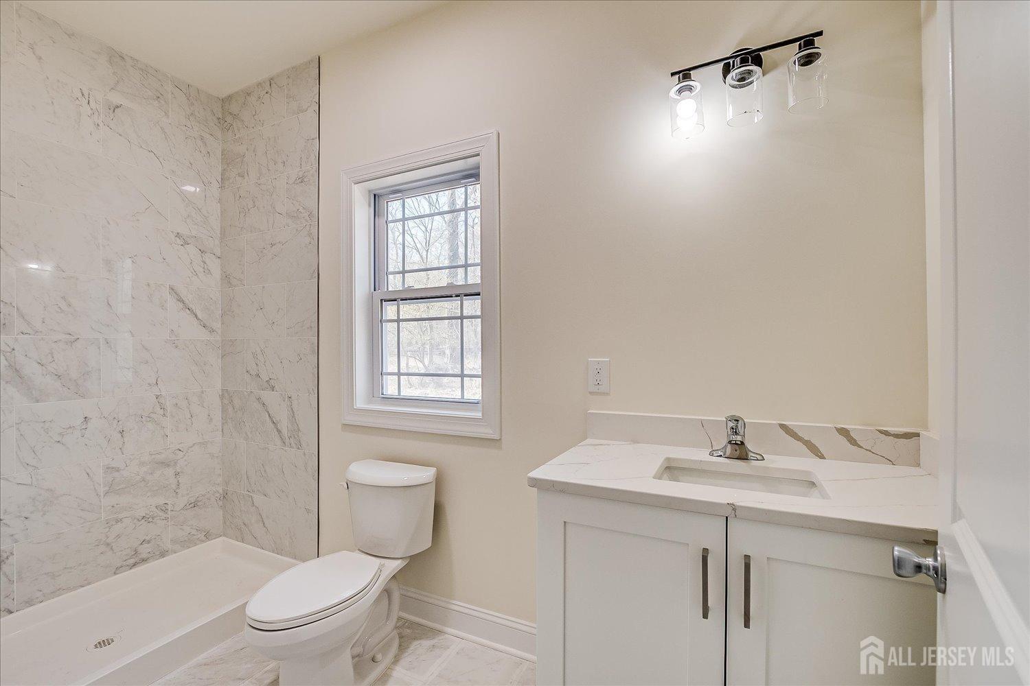 90 Hancock Road Piscataway, NJ 08854 - Photo 22 of 50 a bathroom with a sink a toilet and shower
