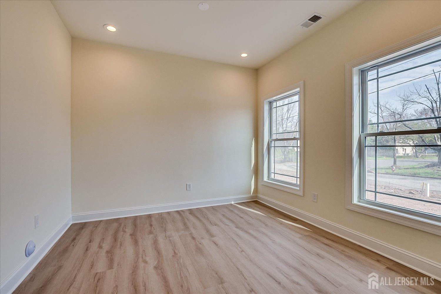 90 Hancock Road Piscataway, NJ 08854 - Photo 24 of 50 a view of an empty room with wooden floor and windows