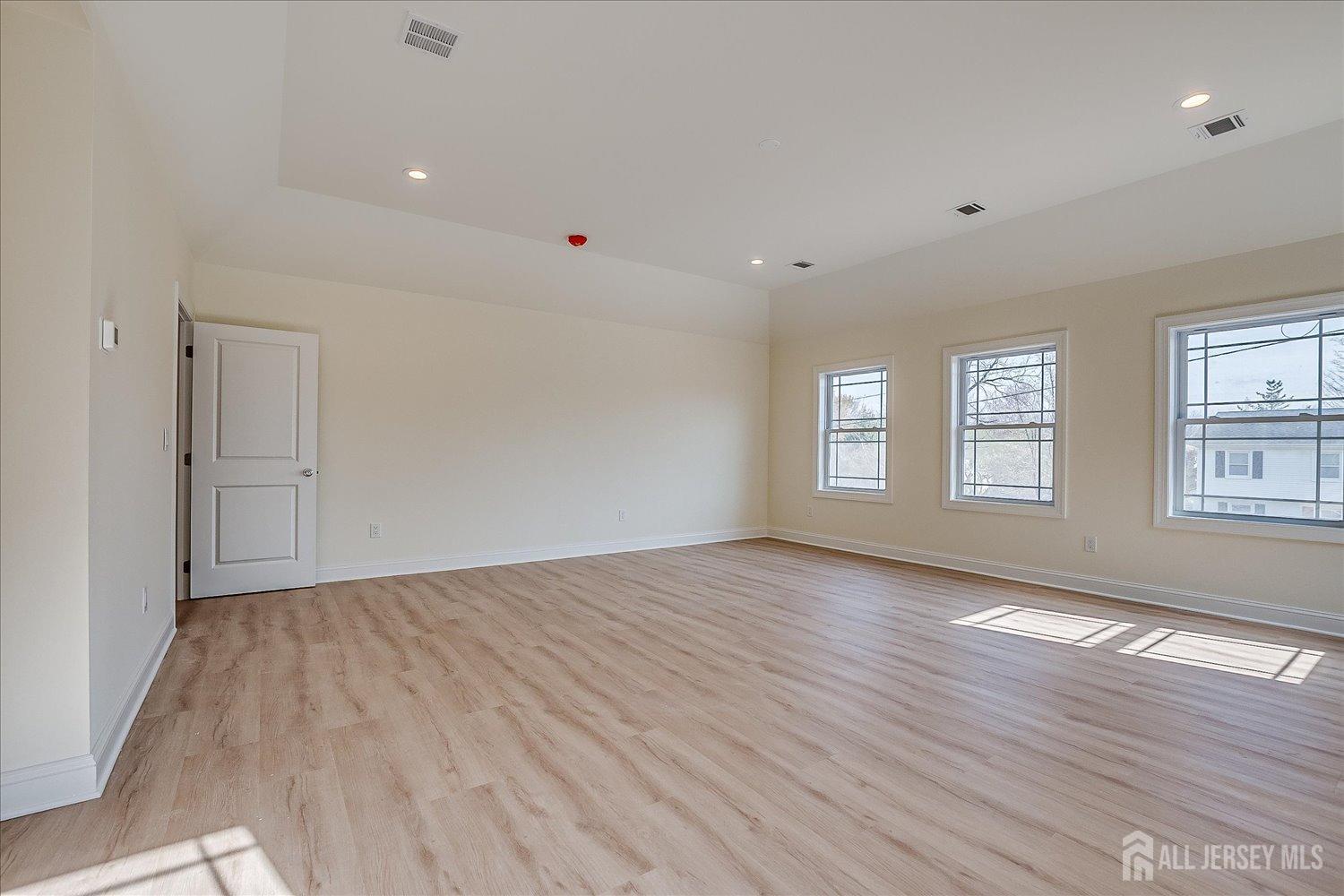 90 Hancock Road Piscataway, NJ 08854 - Photo 34 of 50 an empty room with wooden floor and windows