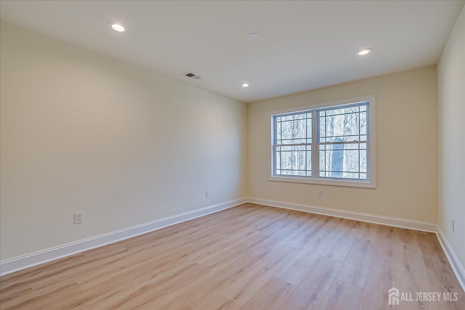 90 Hancock Road Piscataway, NJ 08854 - Photo 38 of 50 a view of an empty room with wooden floor and a window