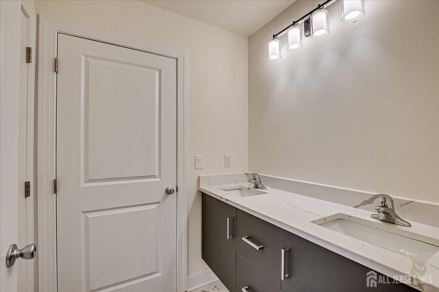 90 Hancock Road Piscataway, NJ 08854 - Photo 40 of 50 a bathroom with a double vanity sink and a mirror