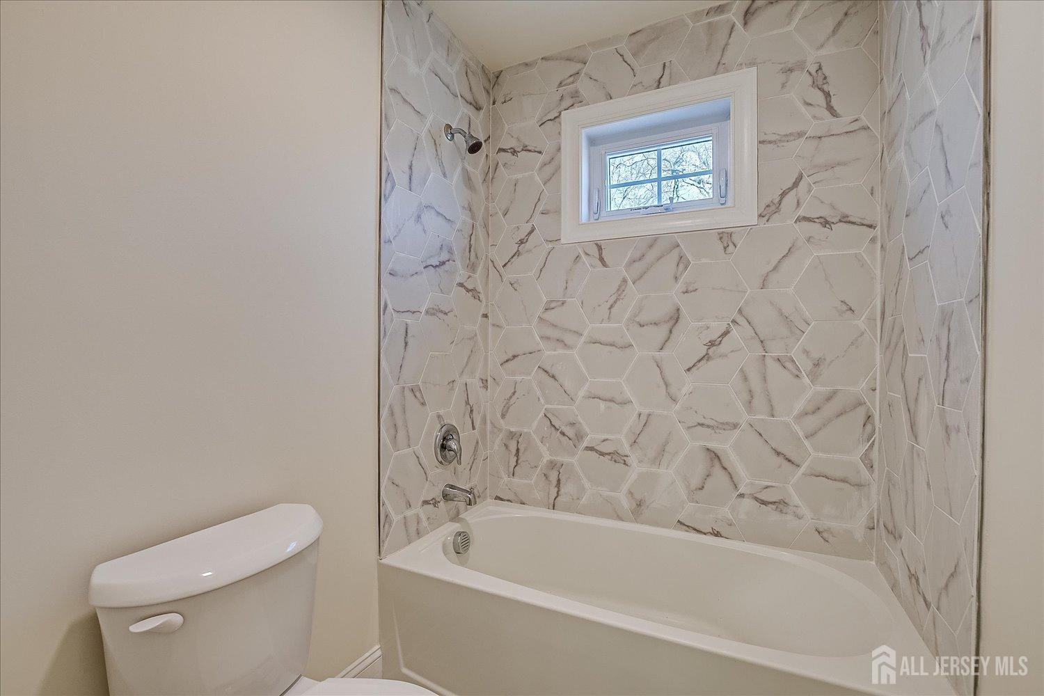 90 Hancock Road Piscataway, NJ 08854 - Photo 41 of 50 a bath tub sitting next to a white toilet and a shower curtain