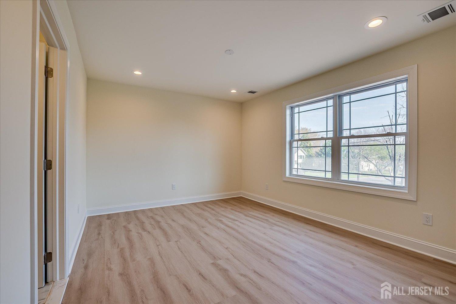 90 Hancock Road Piscataway, NJ 08854 - Photo 42 of 50 an empty room with wooden floor and windows