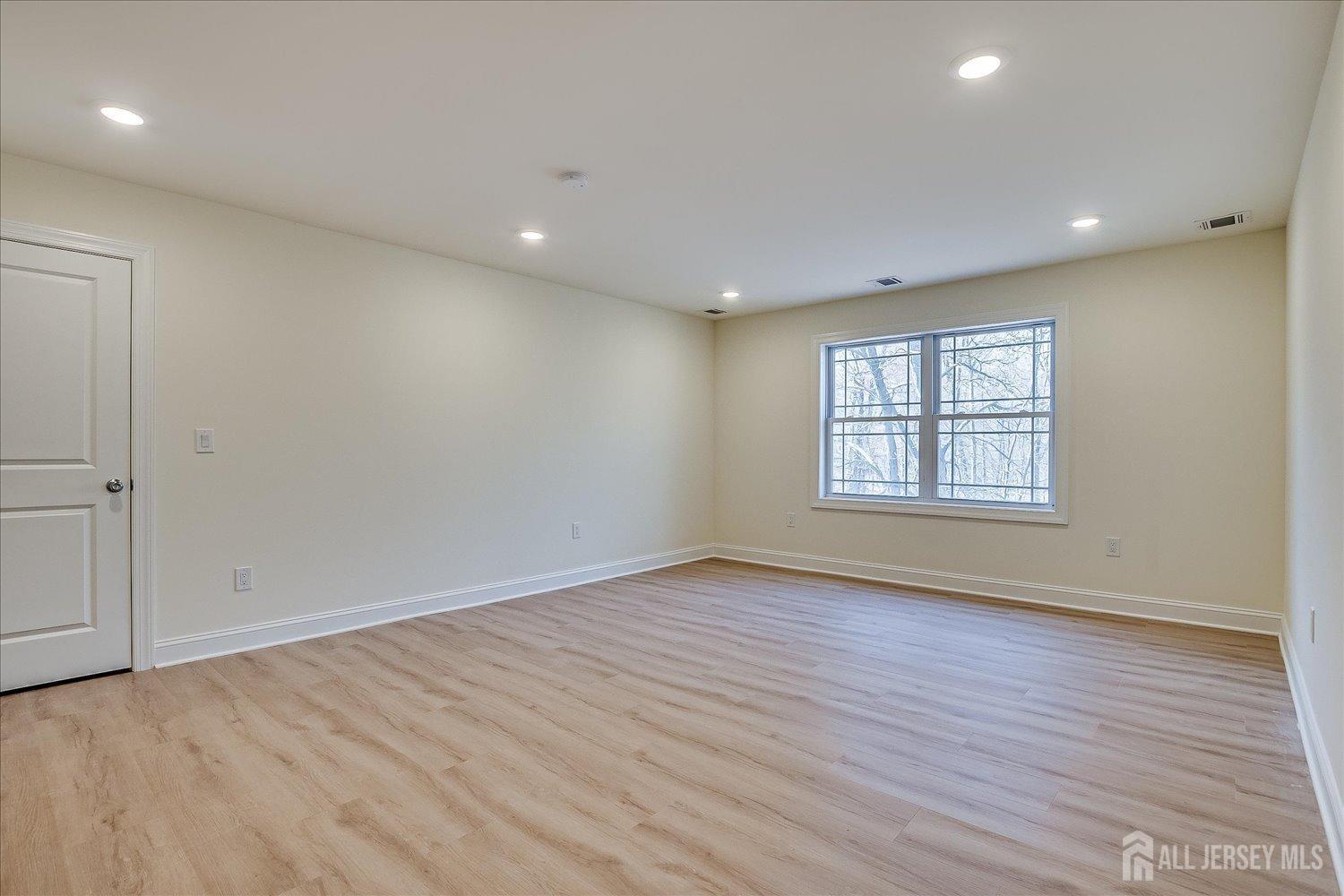 90 Hancock Road Piscataway, NJ 08854 - Photo 49 of 50 an empty room with wooden floor and windows