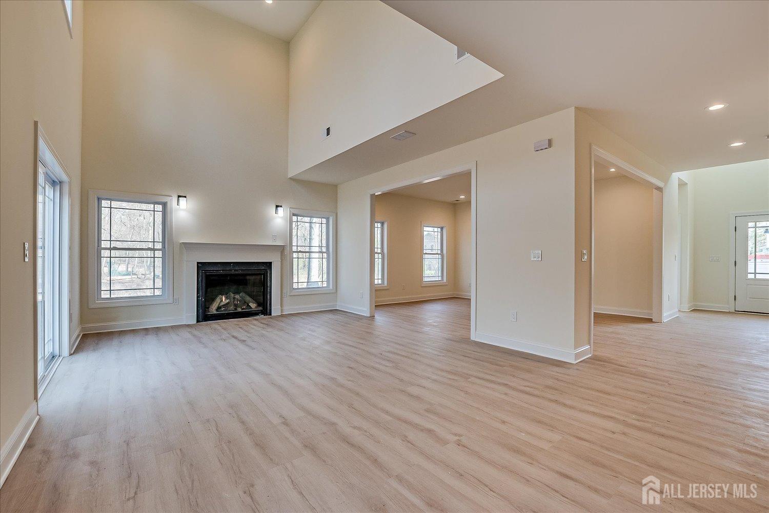 90 Hancock Road Piscataway, NJ 08854 - Photo 9 of 50 a view of an empty room with wooden floor fireplace and a window