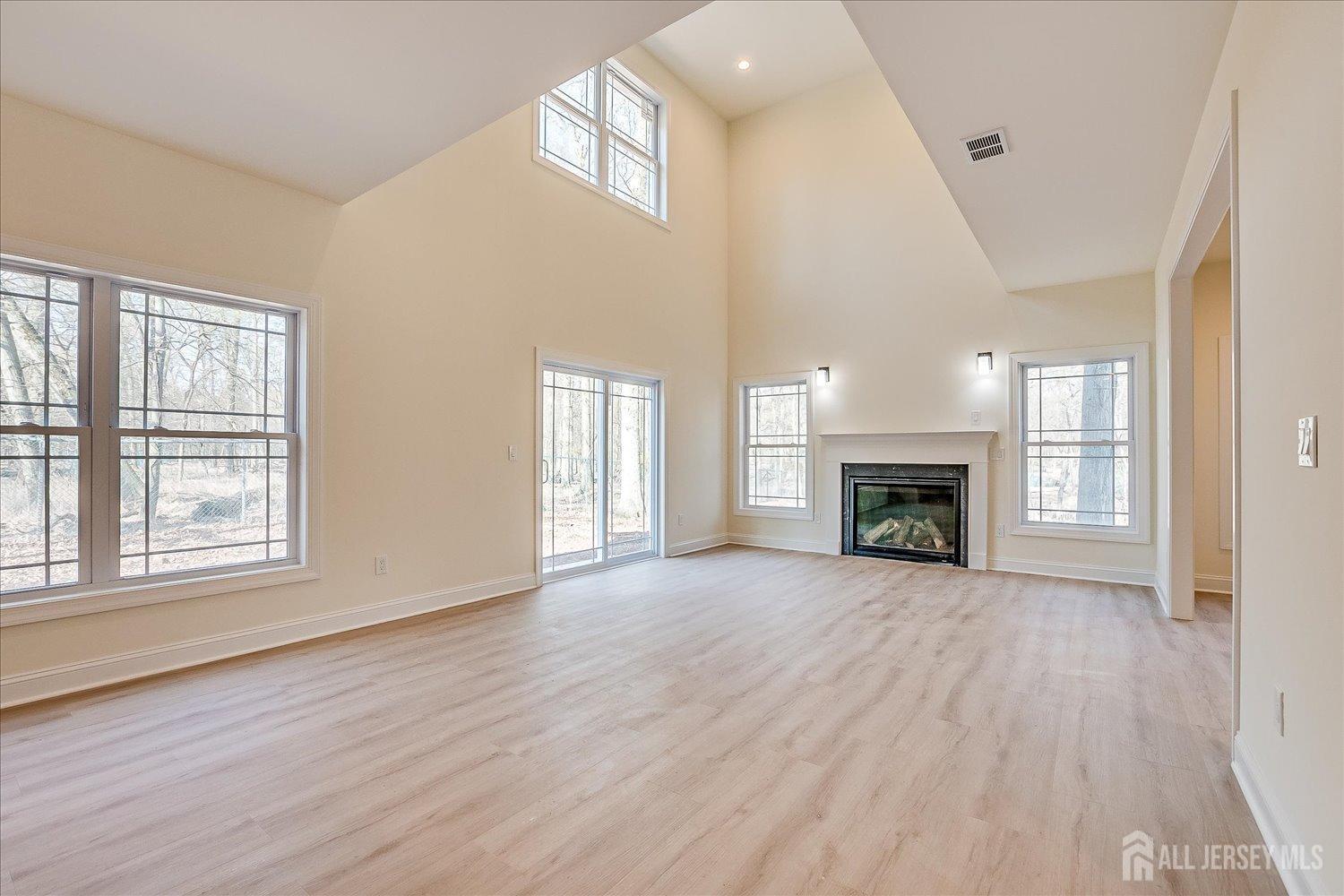 90 Hancock Road Piscataway, NJ 08854 - Photo 10 of 50 an empty room with wooden floor fireplace and windows