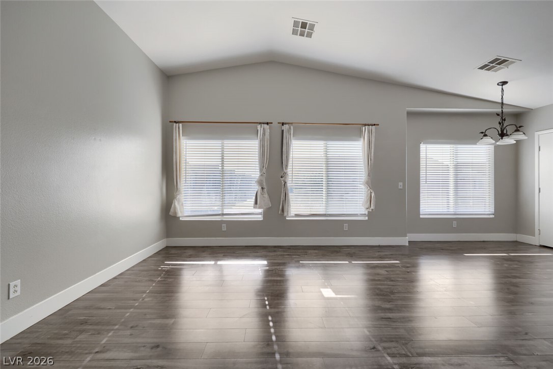 5985 High Steed Street, Unit 101 Henderson, NV 89011 - Photo 6 of 38 Natural light pours into this living space, highlighting the beautiful wood flooring and vaulted ceilings.