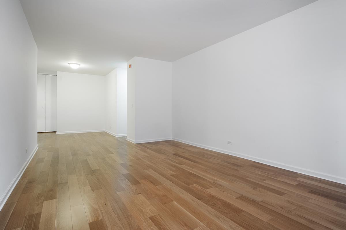 60 East 8th Street, Unit 10P Manhattan, NY 10003 - Photo 3 of 8 a view of empty room with wooden floor