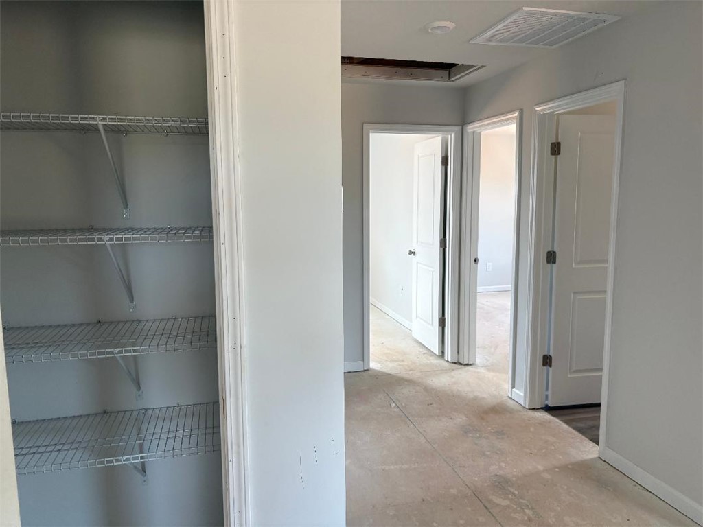 129 Cedar Shoals Easley, SC 29640 - Photo 20 of 31 Essential closet organization solutions provide ample storage in this well-lit hallway.