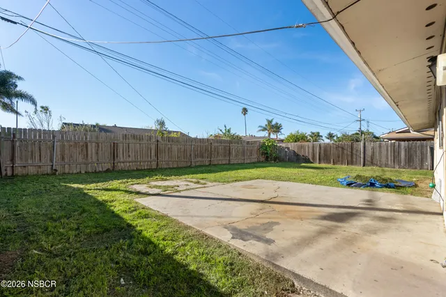 a view of a backyard with plants and a garden