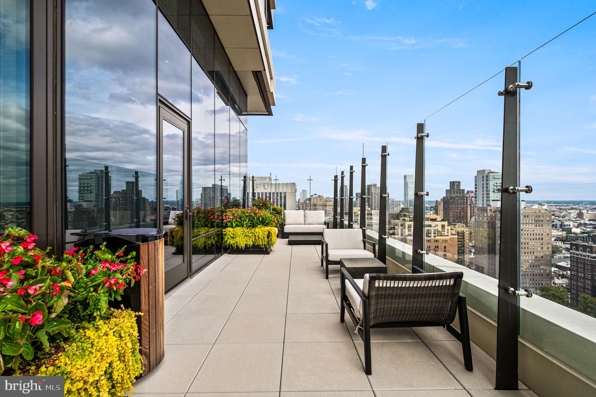 1911 Walnut Street, Unit 4102 Philadelphia, PA 19103 - Photo 14 of 25 a roof deck with couch and potted plants