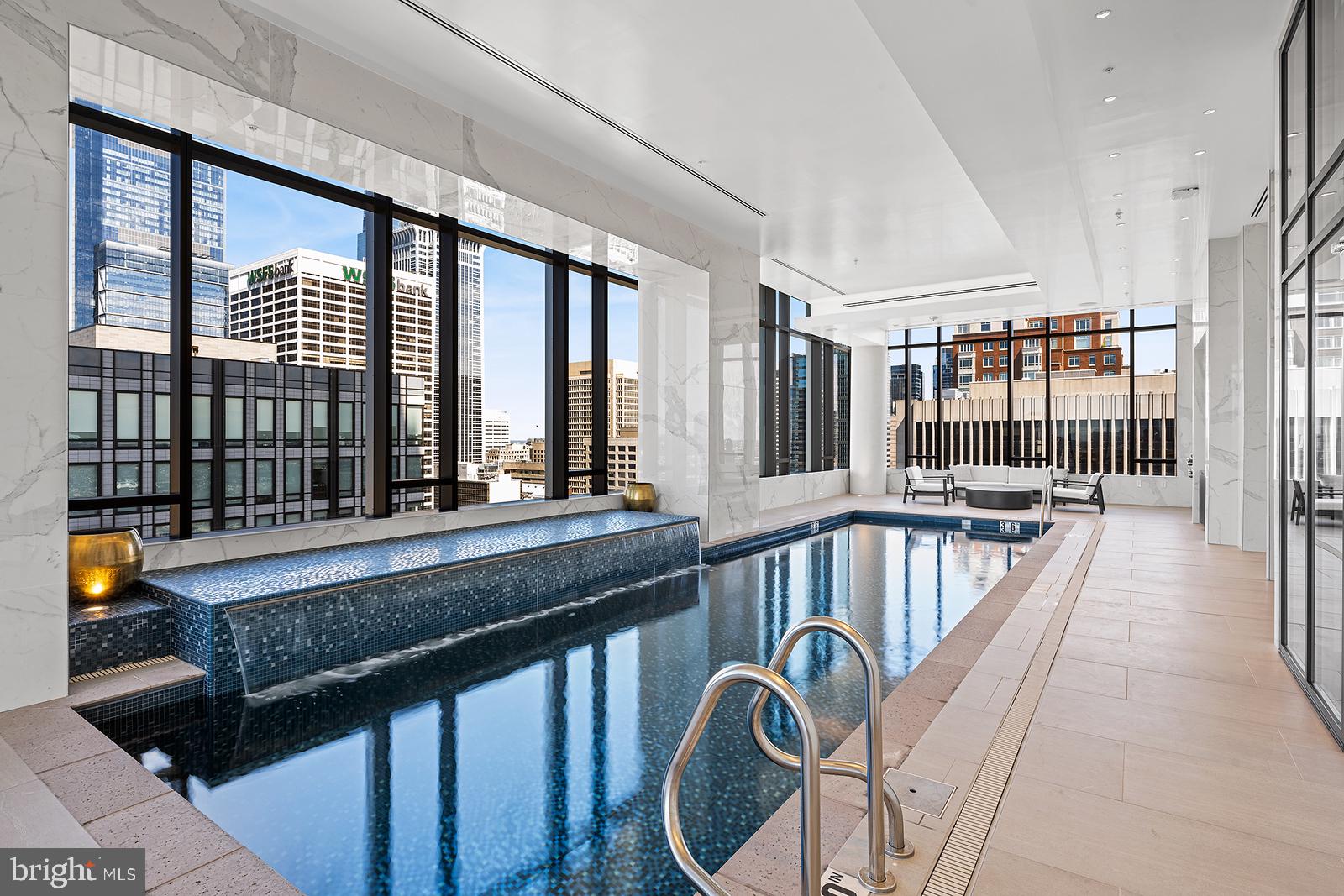 1911 Walnut Street, Unit 4102 Philadelphia, PA 19103 - Photo 18 of 25 a view of a swimming pool with a couch and chairs