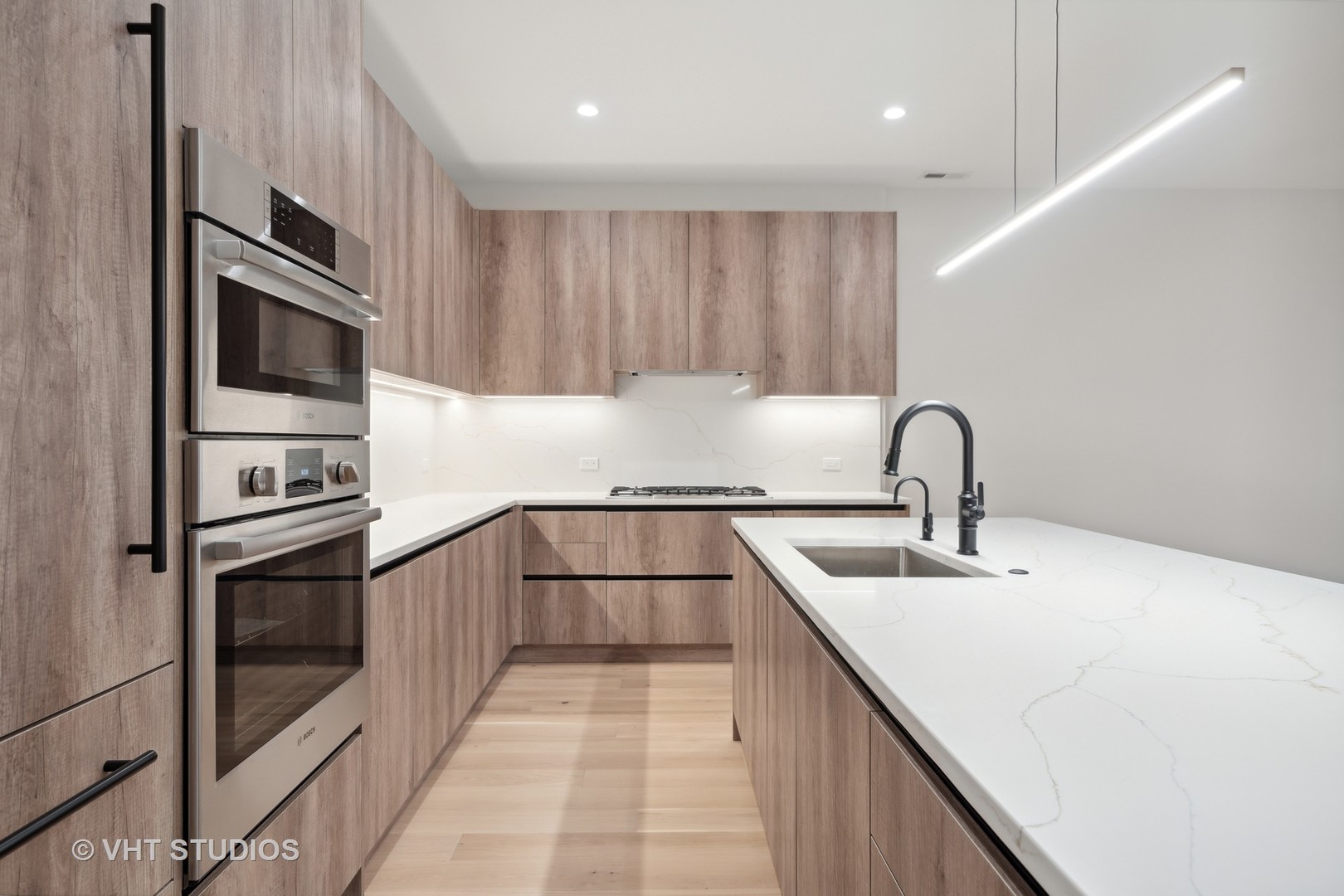 232 South Green Street, Unit 3N Chicago, IL 60607 - Photo 11 of 30 a kitchen with stainless steel appliances granite countertop a sink and dishwasher a stove top oven with wooden floor