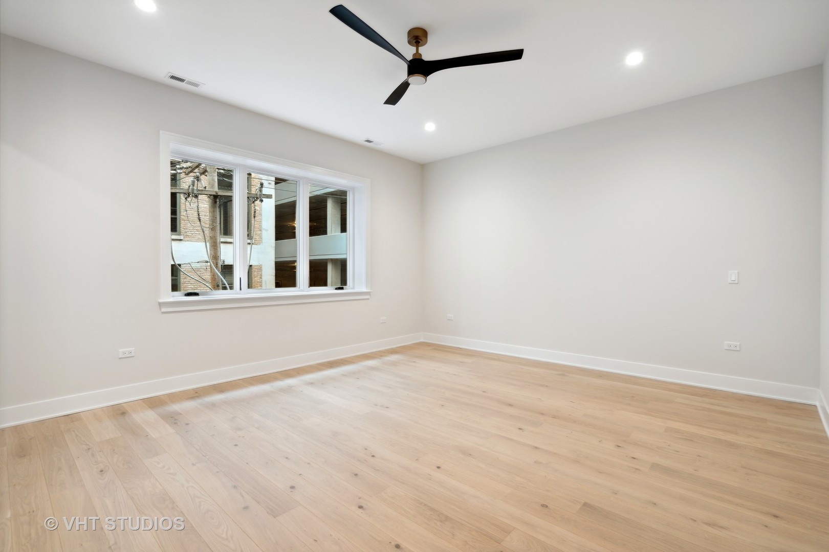 232 South Green Street, Unit 3N Chicago, IL 60607 - Photo 13 of 30 a view of empty room with wooden floor and fan