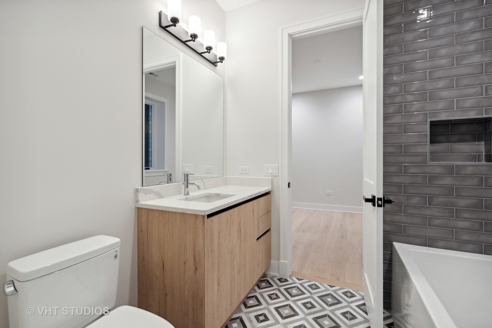 232 South Green Street, Unit 3N Chicago, IL 60607 - Photo 22 of 30 a bathroom with a sink a toilet a shower and a mirror
